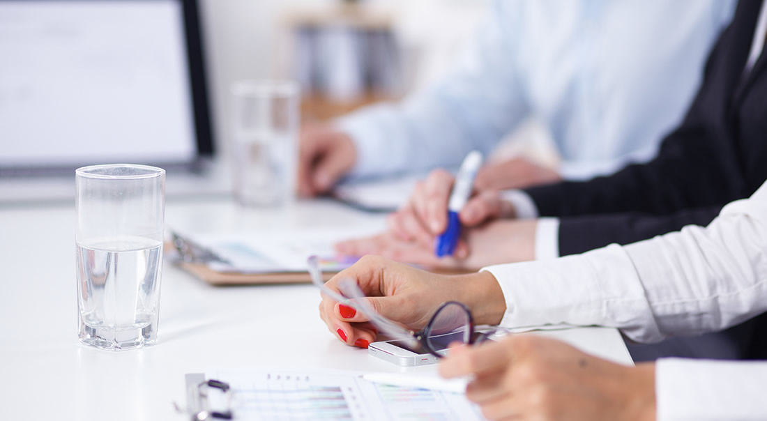 Image of business people taking notes