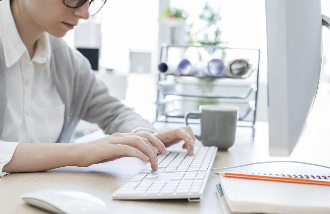 Young man using a computor at a desk